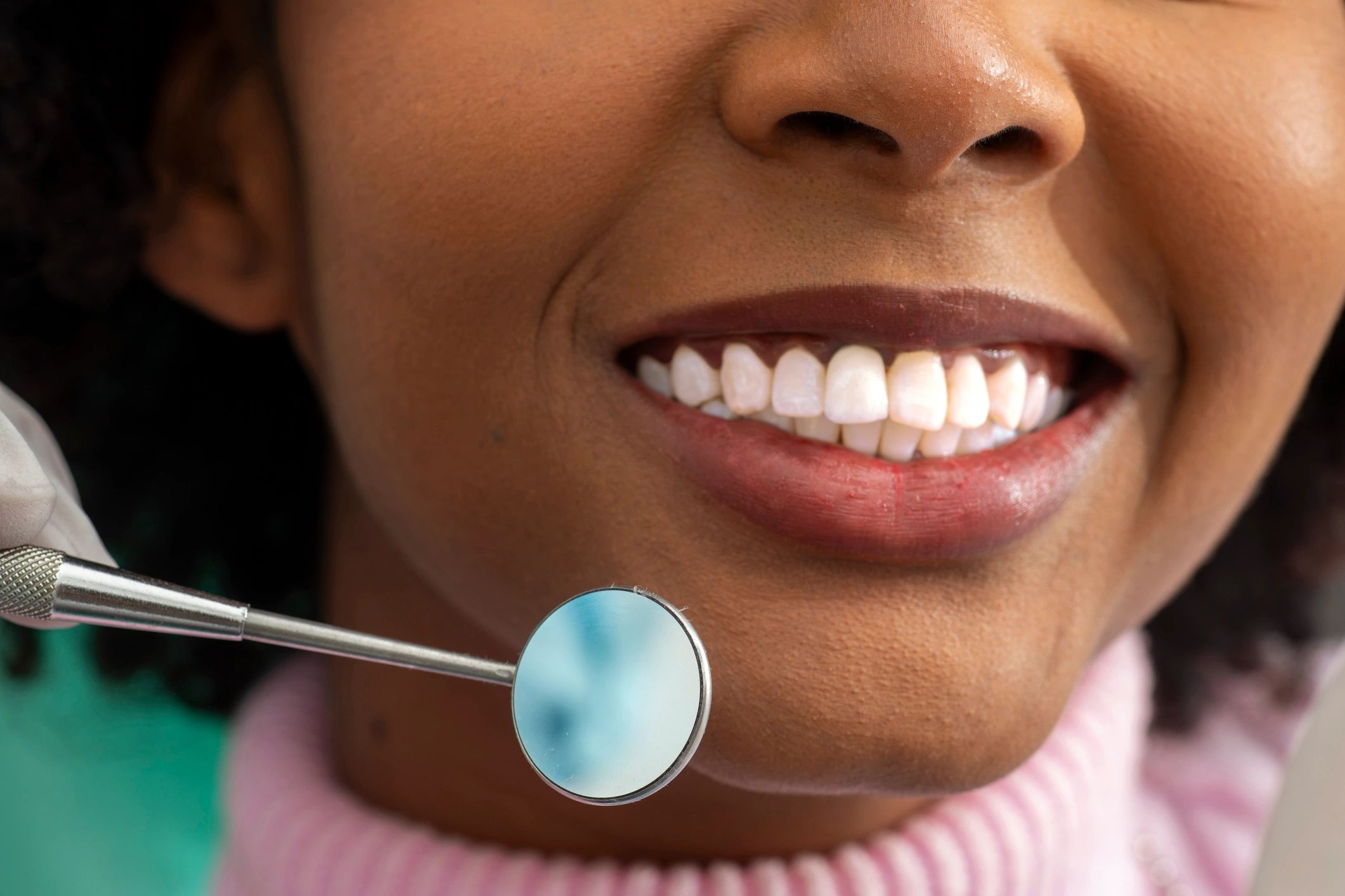 Smiling patient during dental checkup showing healthy confident smile