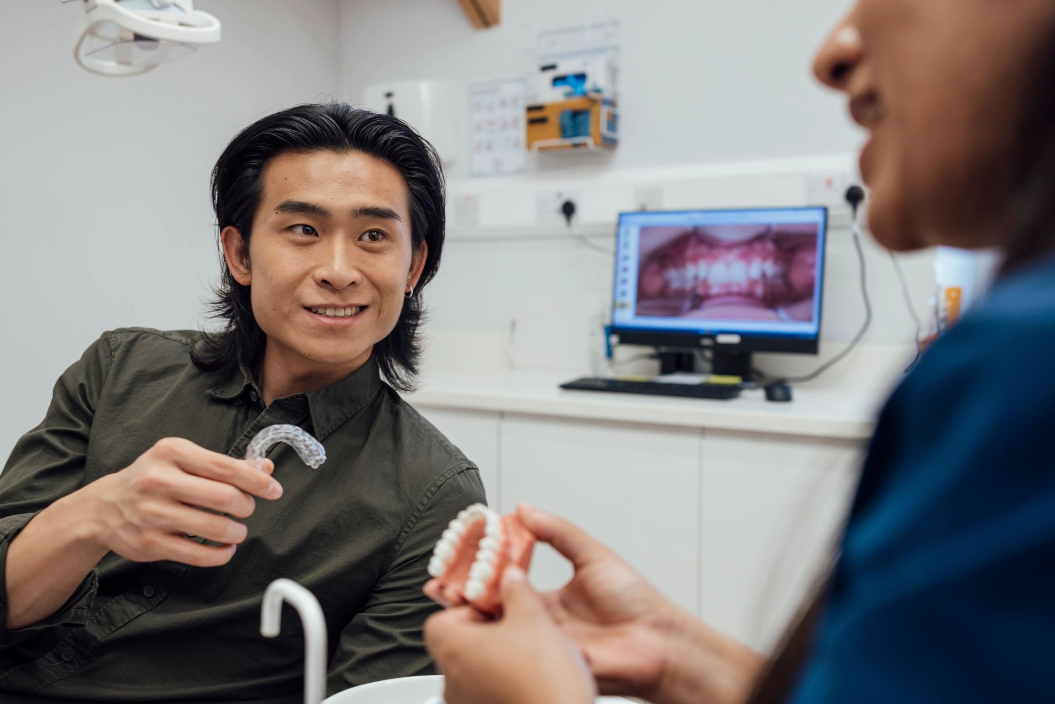 Patient discussing clear aligner treatment with orthodontist