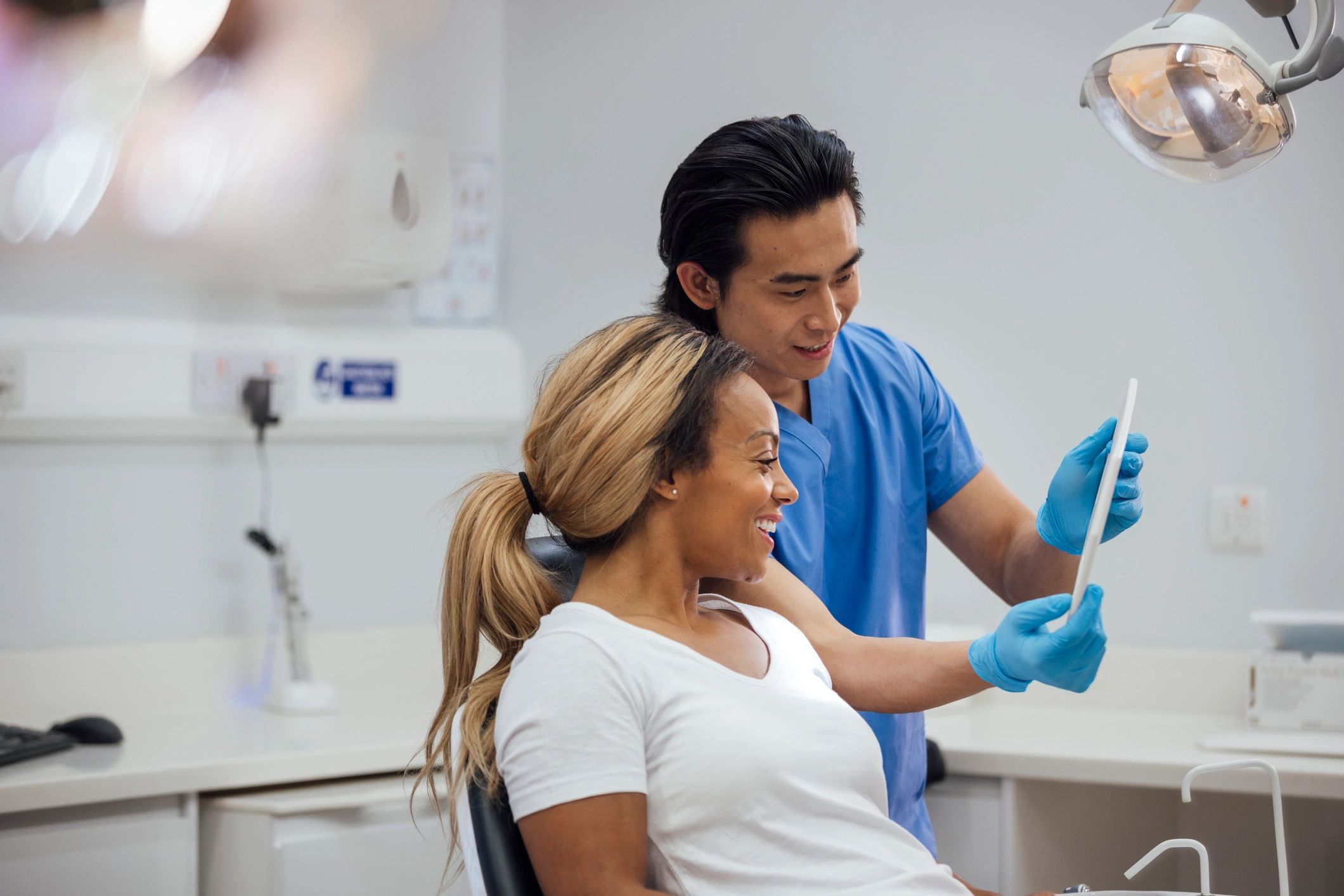 Orthodontist reviewing treatment progress with patient in clinic