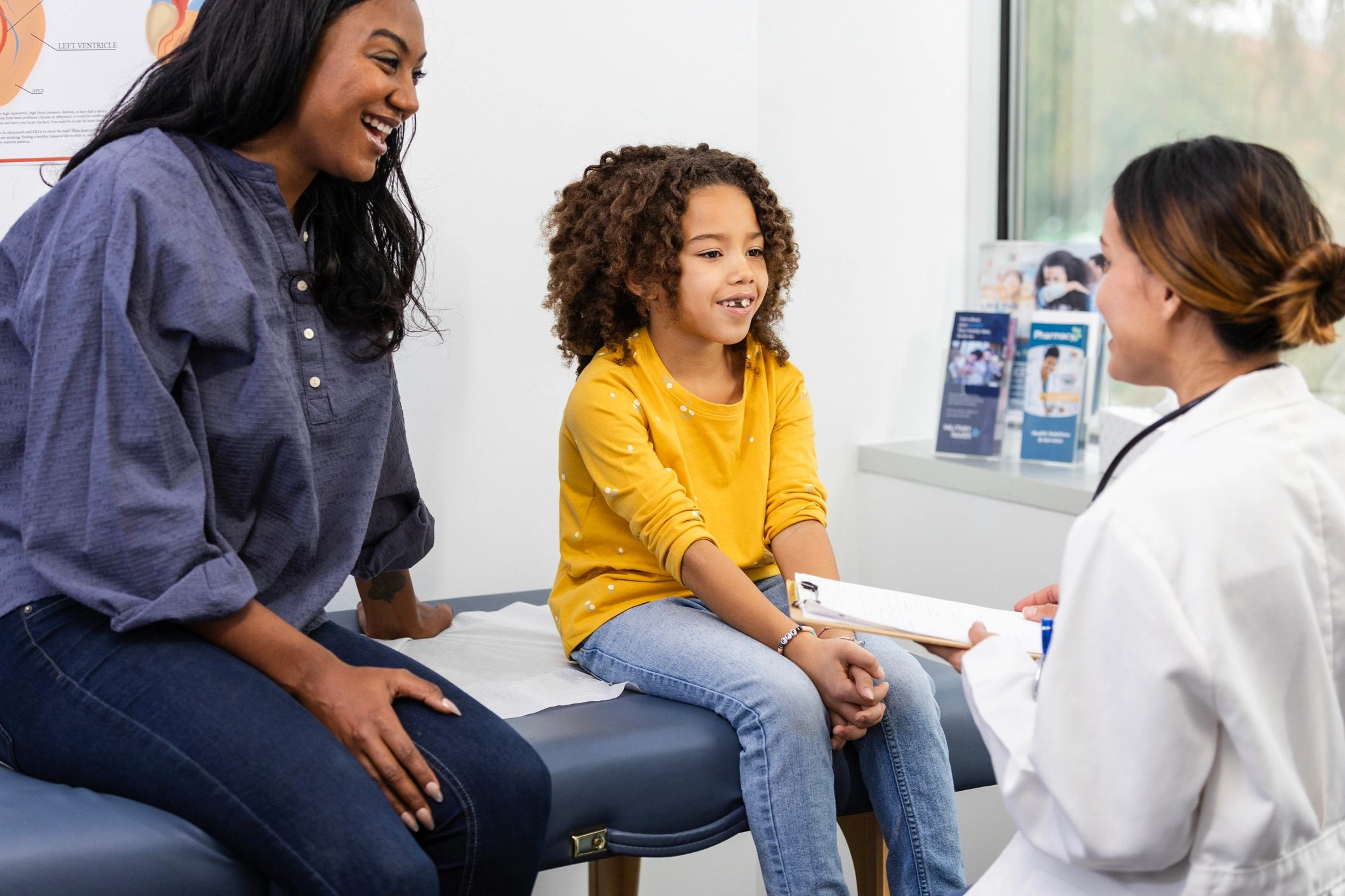 Dentist speaking with a young patient during a pediatric dental visit